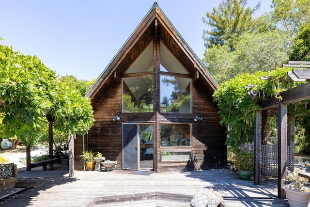 back of house with a wooden deck