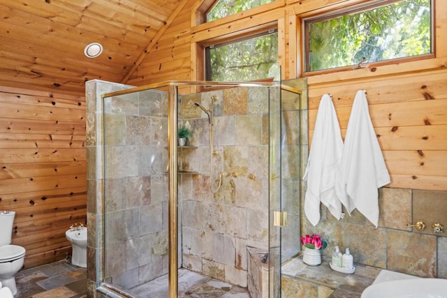 bathroom with a shower with door, a bidet, vaulted ceiling, and wooden walls