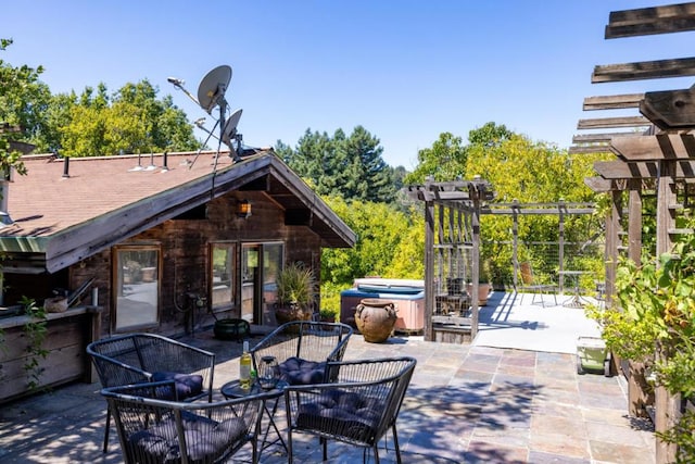 view of patio with a hot tub and a pergola