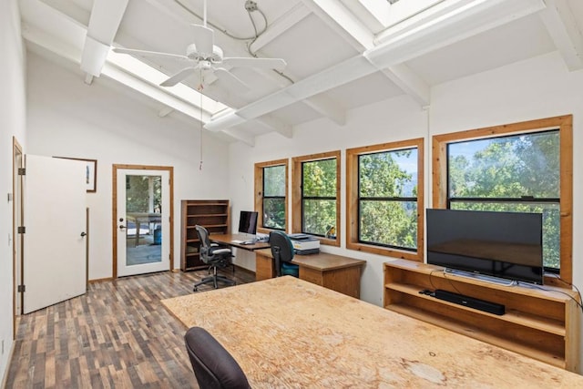 office area with ceiling fan, wood-type flooring, and vaulted ceiling with skylight