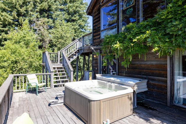 wooden terrace with a hot tub