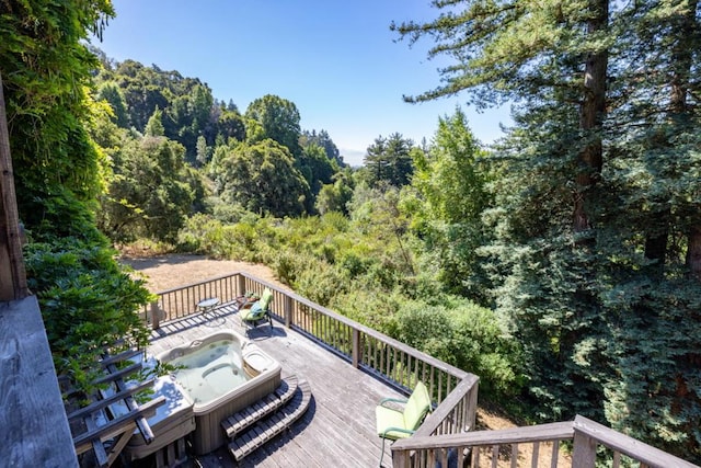 wooden deck featuring an outdoor hot tub