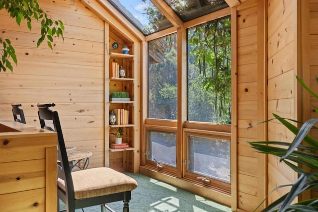 sunroom / solarium featuring a healthy amount of sunlight and a skylight