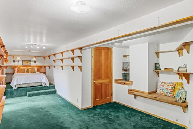 unfurnished bedroom with dark colored carpet and a textured ceiling