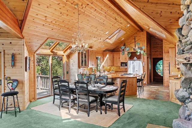 carpeted dining room featuring wood ceiling, a skylight, wooden walls, and beamed ceiling