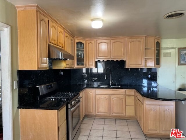 kitchen with tasteful backsplash, stainless steel gas range, sink, light brown cabinets, and light tile patterned flooring