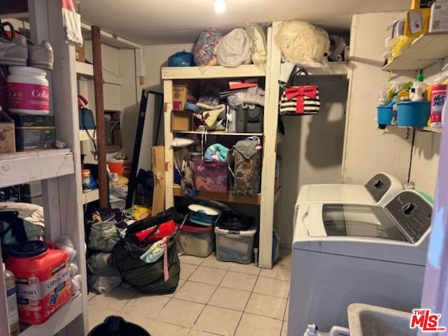 laundry room featuring separate washer and dryer and light tile patterned floors