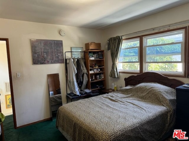 bedroom featuring dark colored carpet