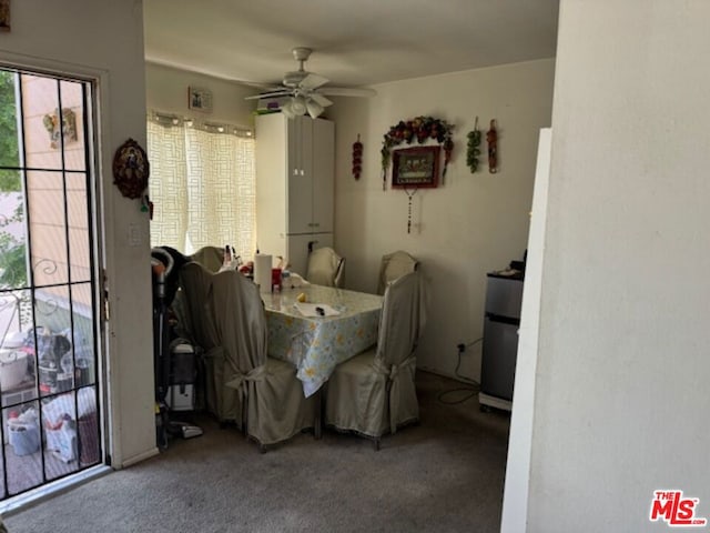 dining space with carpet and ceiling fan