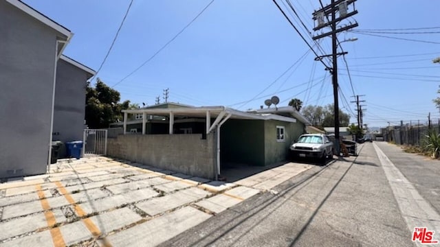 view of side of property with a carport