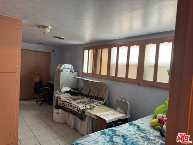 bedroom featuring light tile patterned floors