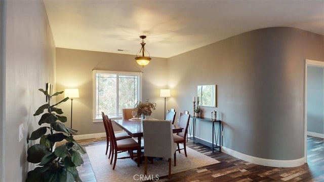 dining area with dark hardwood / wood-style floors