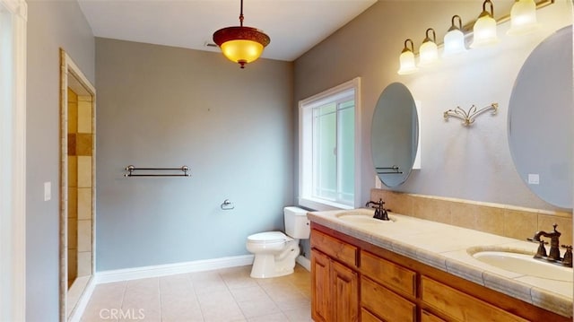 bathroom featuring vanity, toilet, tile patterned flooring, and an enclosed shower