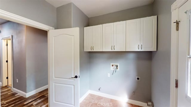 laundry room featuring hookup for a washing machine, electric dryer hookup, cabinets, and hardwood / wood-style floors