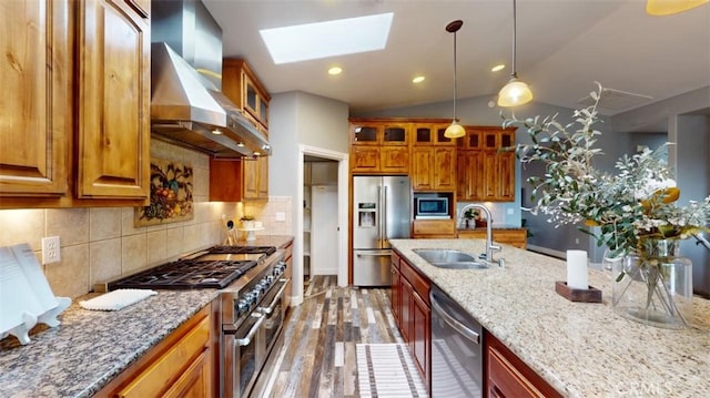 kitchen featuring dark hardwood / wood-style floors, wall chimney exhaust hood, sink, vaulted ceiling with skylight, and appliances with stainless steel finishes