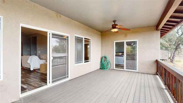 wooden deck featuring ceiling fan