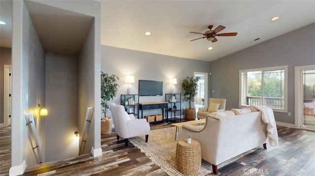 living room featuring lofted ceiling, dark wood-type flooring, and ceiling fan