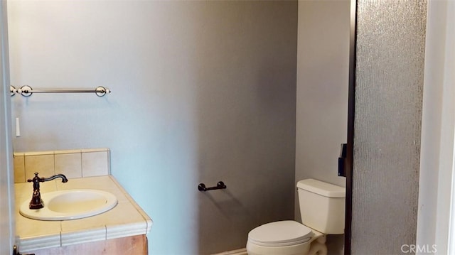 bathroom with toilet and vanity