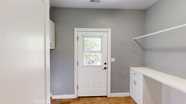 doorway to outside featuring light tile patterned floors