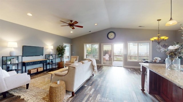 living room with lofted ceiling, dark wood-type flooring, and ceiling fan with notable chandelier