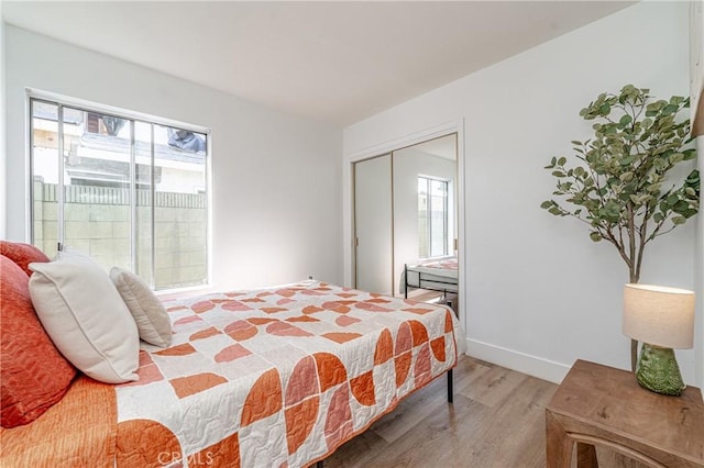 bedroom featuring hardwood / wood-style flooring and a closet