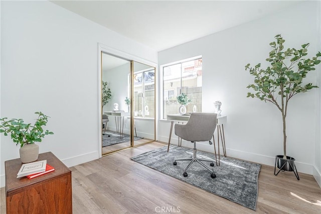 office with light wood-type flooring