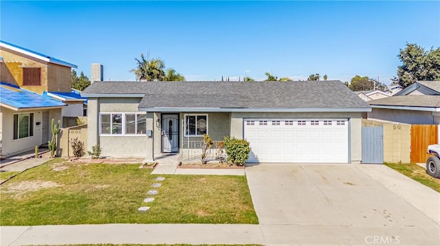 view of front of property with a porch, a garage, and a front lawn