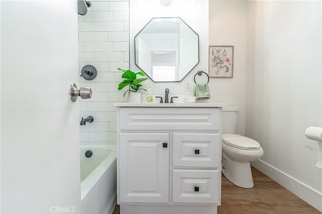 full bathroom featuring tiled shower / bath, toilet, vanity, and hardwood / wood-style flooring