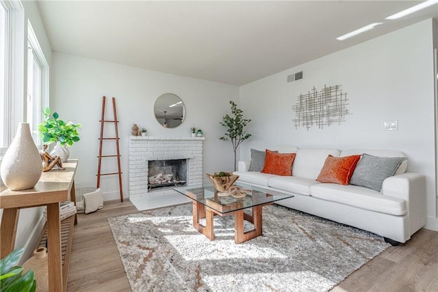 living room featuring a fireplace and light hardwood / wood-style floors