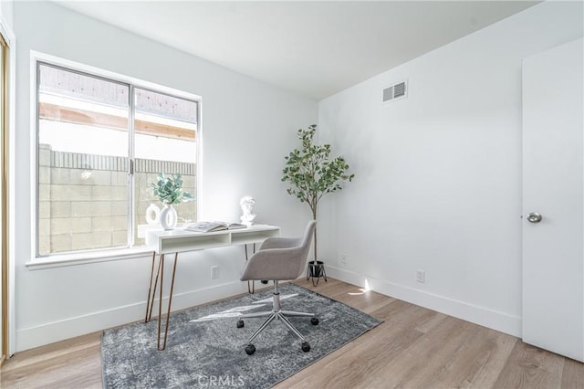 office with light wood-type flooring