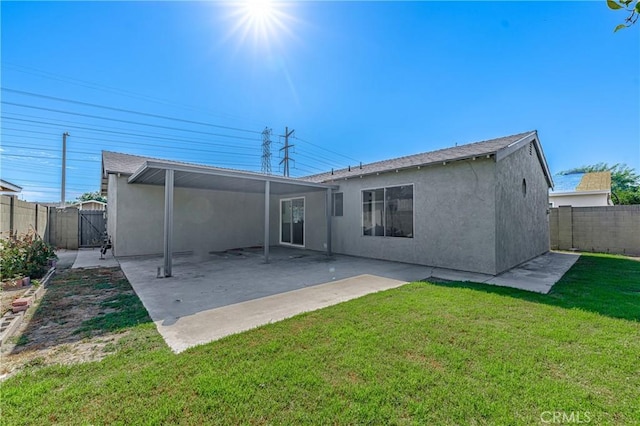 rear view of house with a yard and a patio area