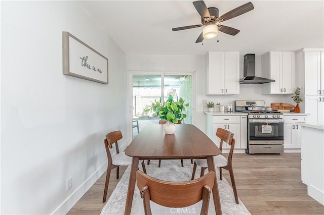 dining space with ceiling fan and light hardwood / wood-style flooring