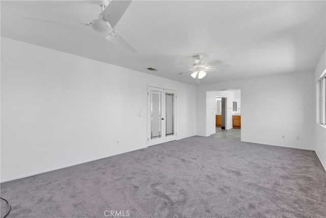 empty room featuring carpet flooring and ceiling fan