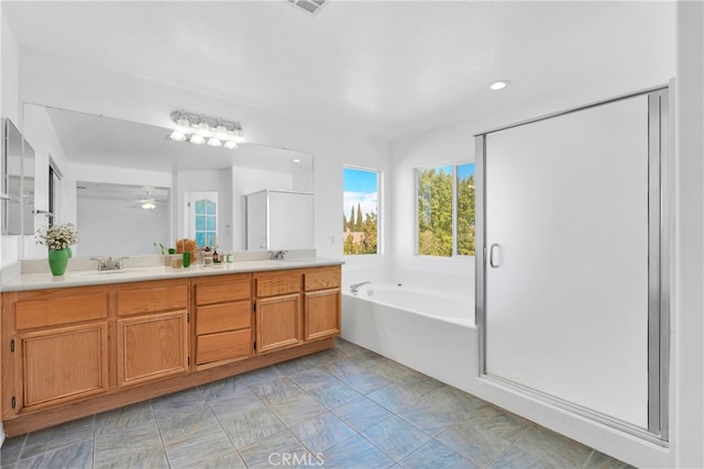 bathroom featuring vanity and independent shower and bath