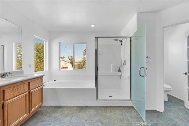 full bathroom featuring separate shower and tub, vanity, a textured ceiling, and toilet