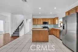 kitchen featuring a center island, light tile patterned floors, and appliances with stainless steel finishes