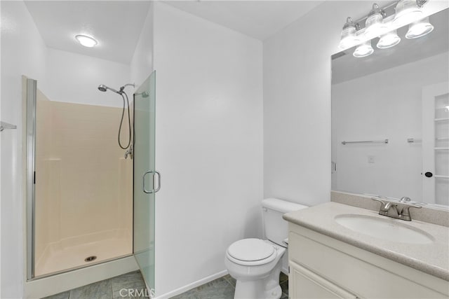 bathroom featuring tile patterned floors, vanity, a shower with shower door, and toilet