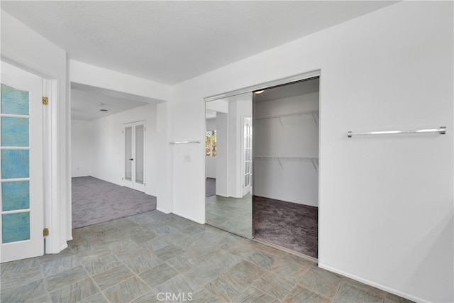 unfurnished bedroom with multiple windows and light colored carpet