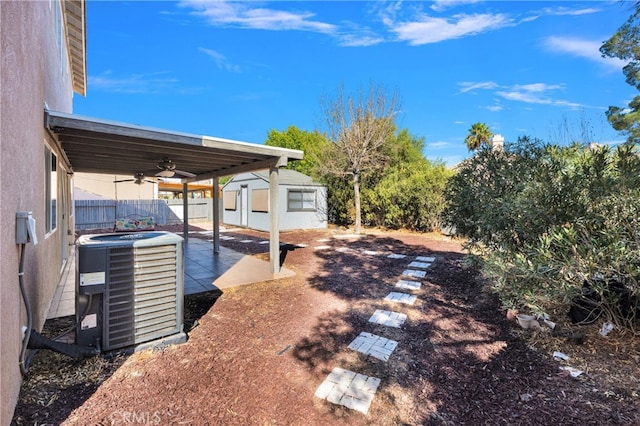 view of yard featuring a patio area, ceiling fan, and cooling unit