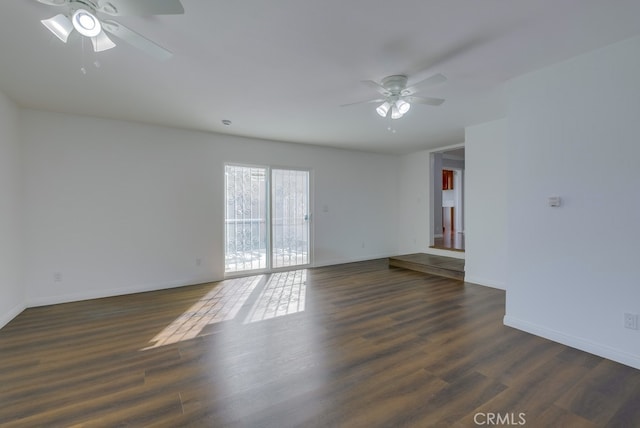 spare room with ceiling fan and dark hardwood / wood-style flooring