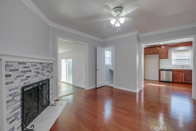 unfurnished living room featuring hardwood / wood-style floors, crown molding, and a healthy amount of sunlight