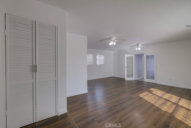 unfurnished living room featuring french doors, dark hardwood / wood-style floors, and ceiling fan