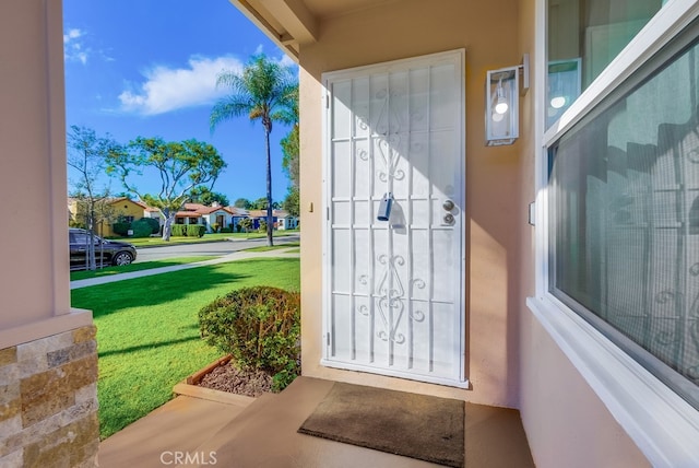 entrance to property with a yard