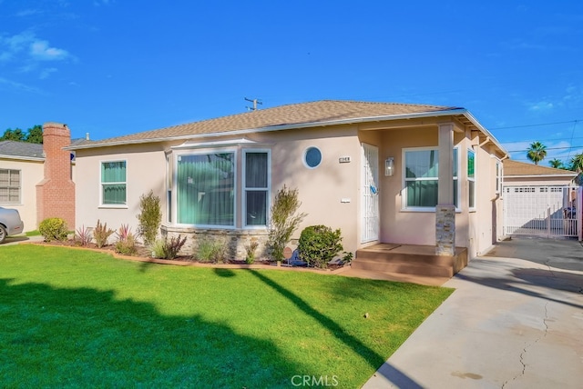 view of front of home featuring a garage and a front lawn