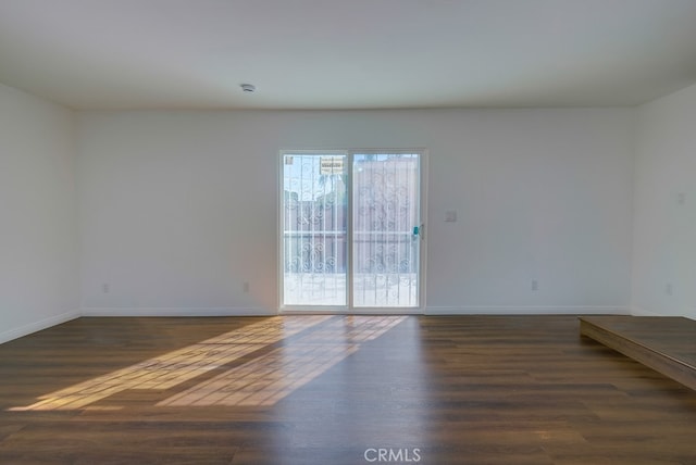 empty room featuring dark wood-type flooring