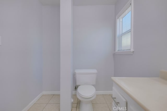 bathroom with tile patterned floors, vanity, and toilet