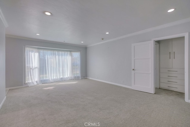 empty room with light colored carpet and ornamental molding