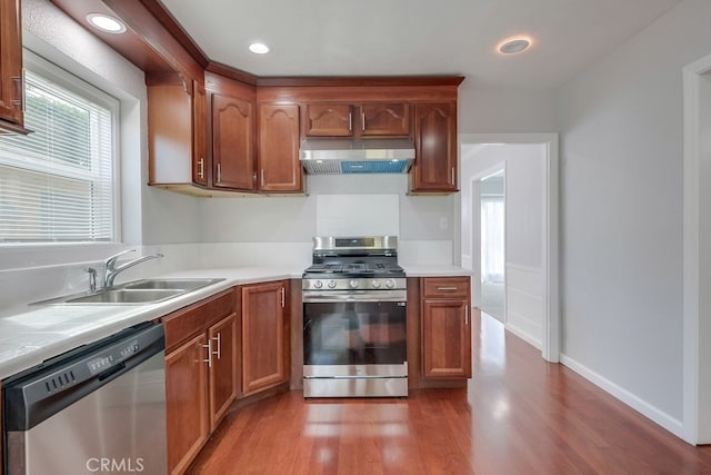 kitchen featuring dark hardwood / wood-style flooring, sink, and stainless steel appliances