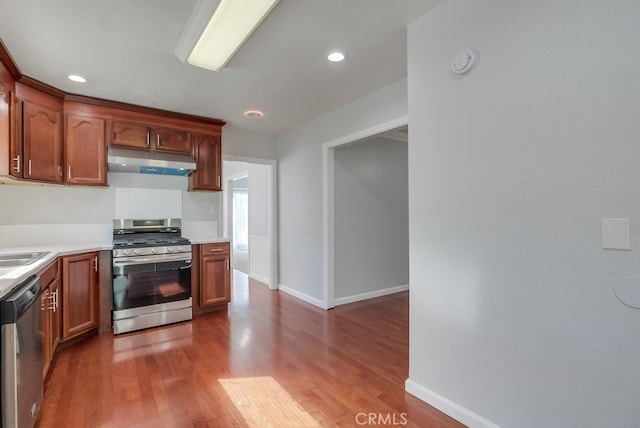 kitchen featuring dark hardwood / wood-style flooring and appliances with stainless steel finishes