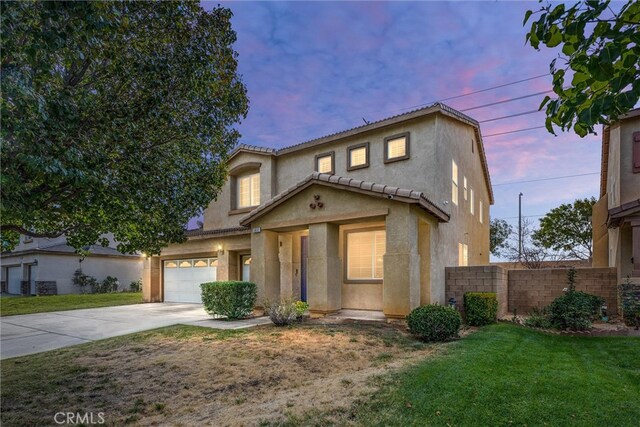 view of front of house with a yard and a garage